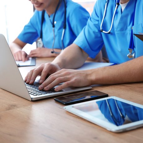 Medical students studying at table, closeup view